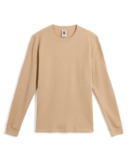 A beige long-sleeve waffle knit shirt with ribbed cuffs and a small embroidered Dandy Del Mar logo on the chest, known as The Cannes Long Sleeve Shirt in Truffle by Dandy Del Mar.