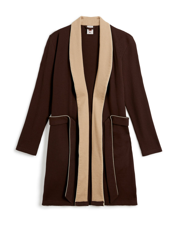 The Cannes Waffle Knit Robe - Carajillo by Dandy Del Mar is a long brown robe featuring a beige trim around the collar and two front pockets with beige detailing, crafted from 100% cotton in luxurious waffle knit fabric.