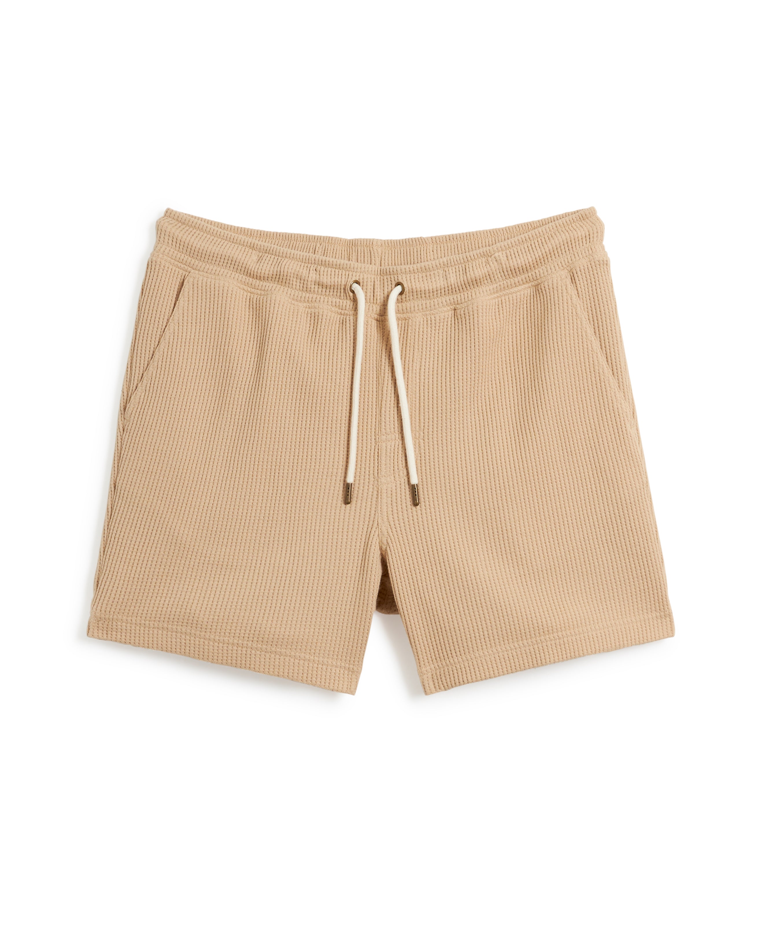 The Cannes Waffle Knit Shorts - Truffle by Dandy Del Mar: Truffle-colored drawstring shorts with two side pockets, featuring a ribbed texture and crafted from 100% cotton waffle knit fabric.