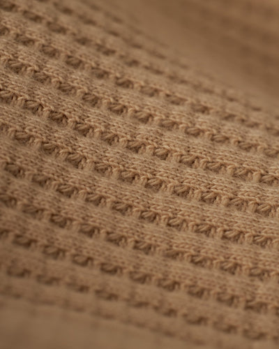Close-up of the Dandy Del Mar Cannes LS Waffle Knit Shirt in Truffle, showcasing its textured beige fabric with horizontal ridges and small square holes.