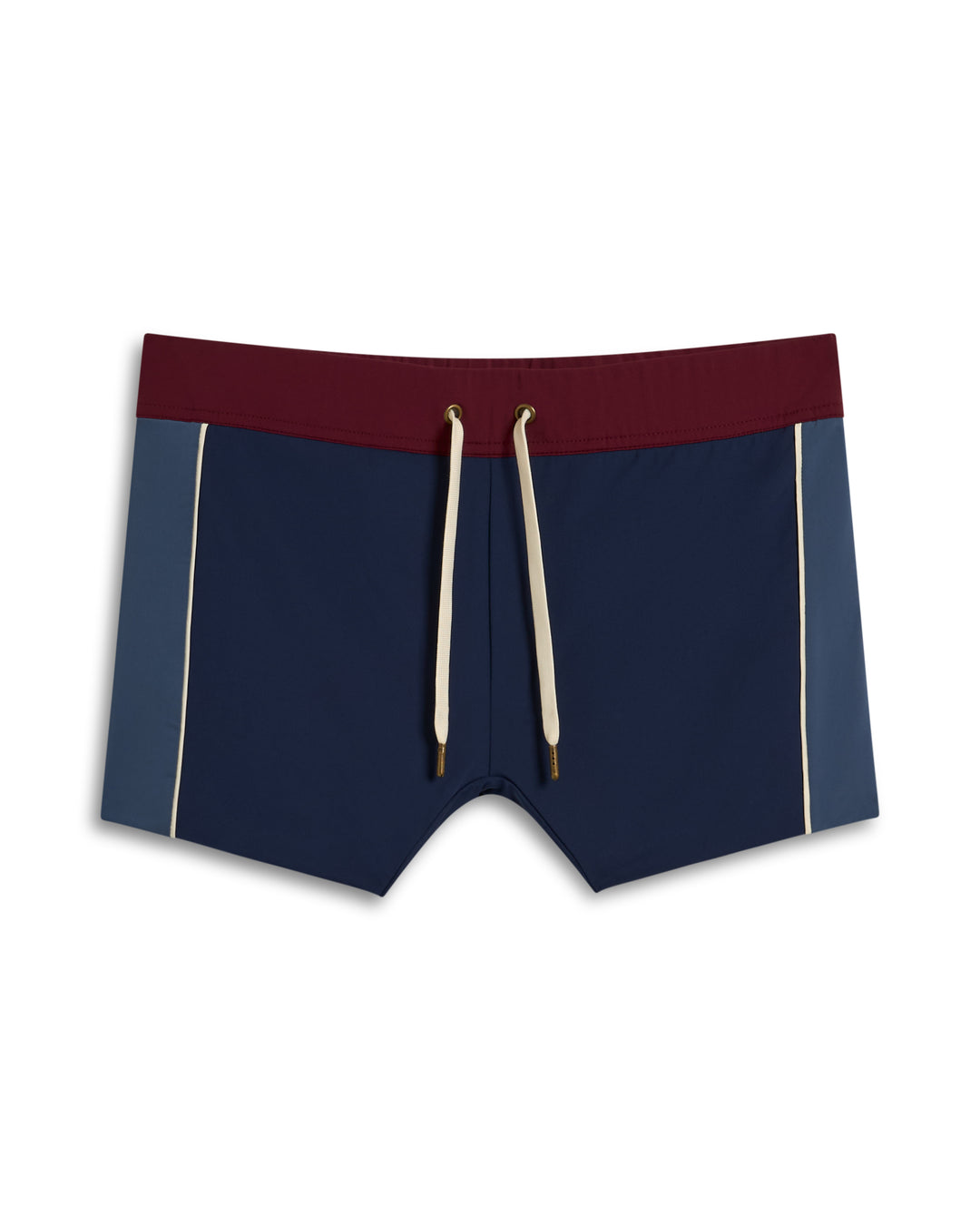 The Cassis Square-Cut Swim Brief by Dandy Del Mar features a maroon waistband, navy front panel, blue side panels, and beige drawstrings.