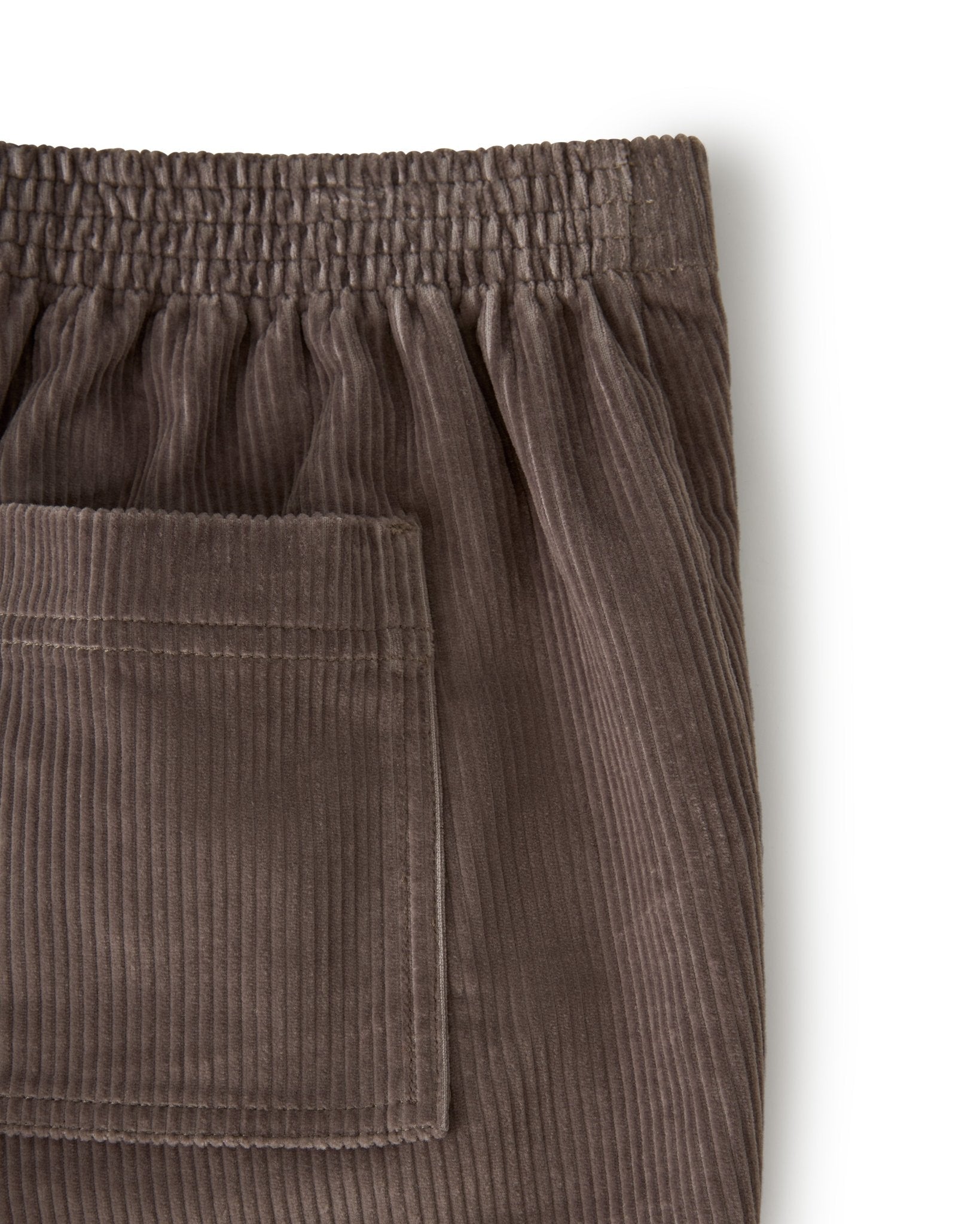 Close-up of the upper section of Dandy Del Mar’s The Corsica Corduroy Shorts in Argento, featuring an elastic waistband and a rectangular back pocket, displayed on a white background.