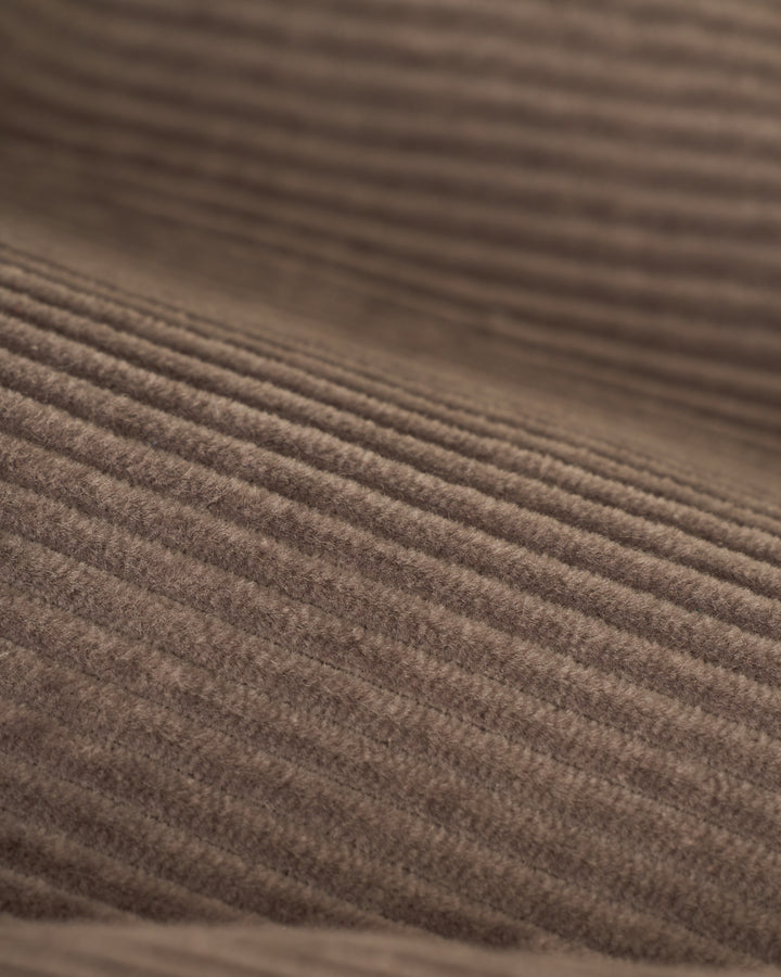 Close-up of The Corsica Corduroy Short - Argento by Dandy Del Mar, highlighting the brown corduroy fabric with its textured, ribbed pattern.