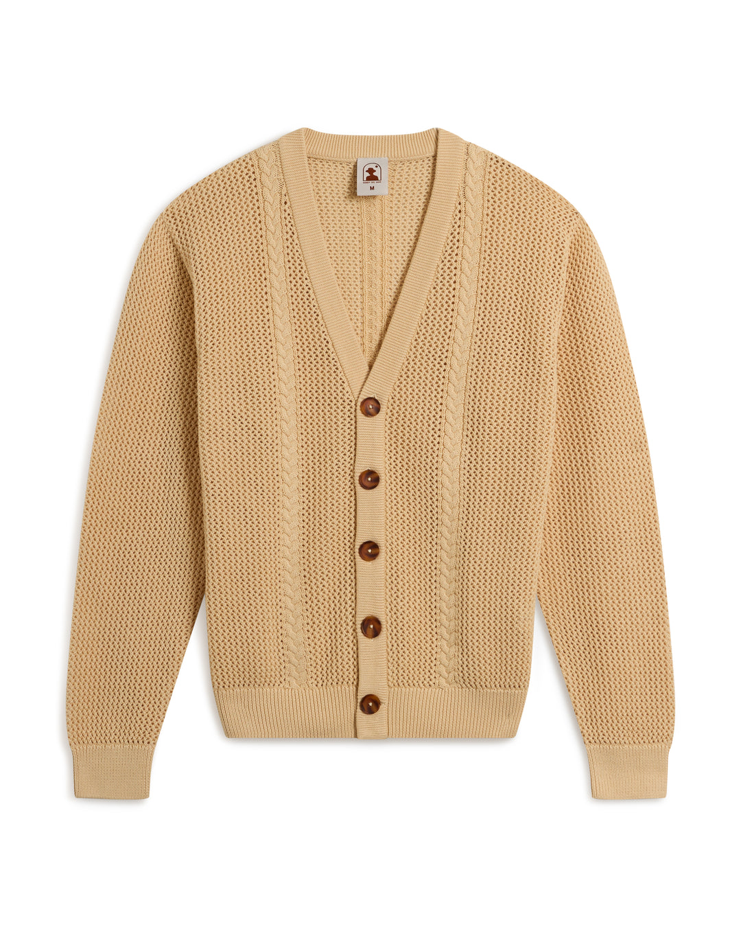 The Crete Crochet Cardigan - Sabbia by Dandy Del Mar is a beige cardigan featuring long sleeves, a V-neck, button closure, and a textured knit pattern.