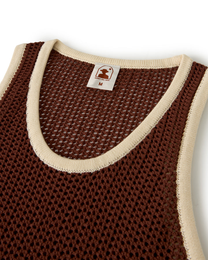 The Dominica Crochet Tank - Cappuccino by Dandy Del Mar is a lightweight brown mesh tank with cream trim, a visible "M" size label, and offers a relaxed fit for any casual outing.