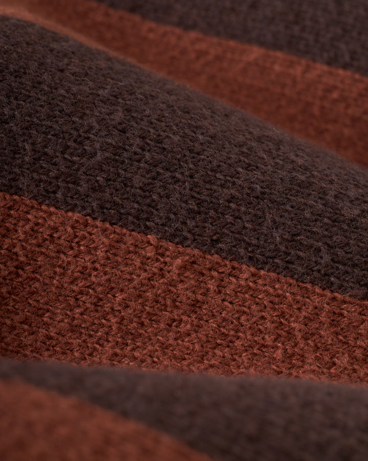 A close-up of the textured Florence Knit Cardigan by Dandy Del Mar, featuring alternating brown and dark brown stripes that highlight the luxurious feel of its jacquard knit.