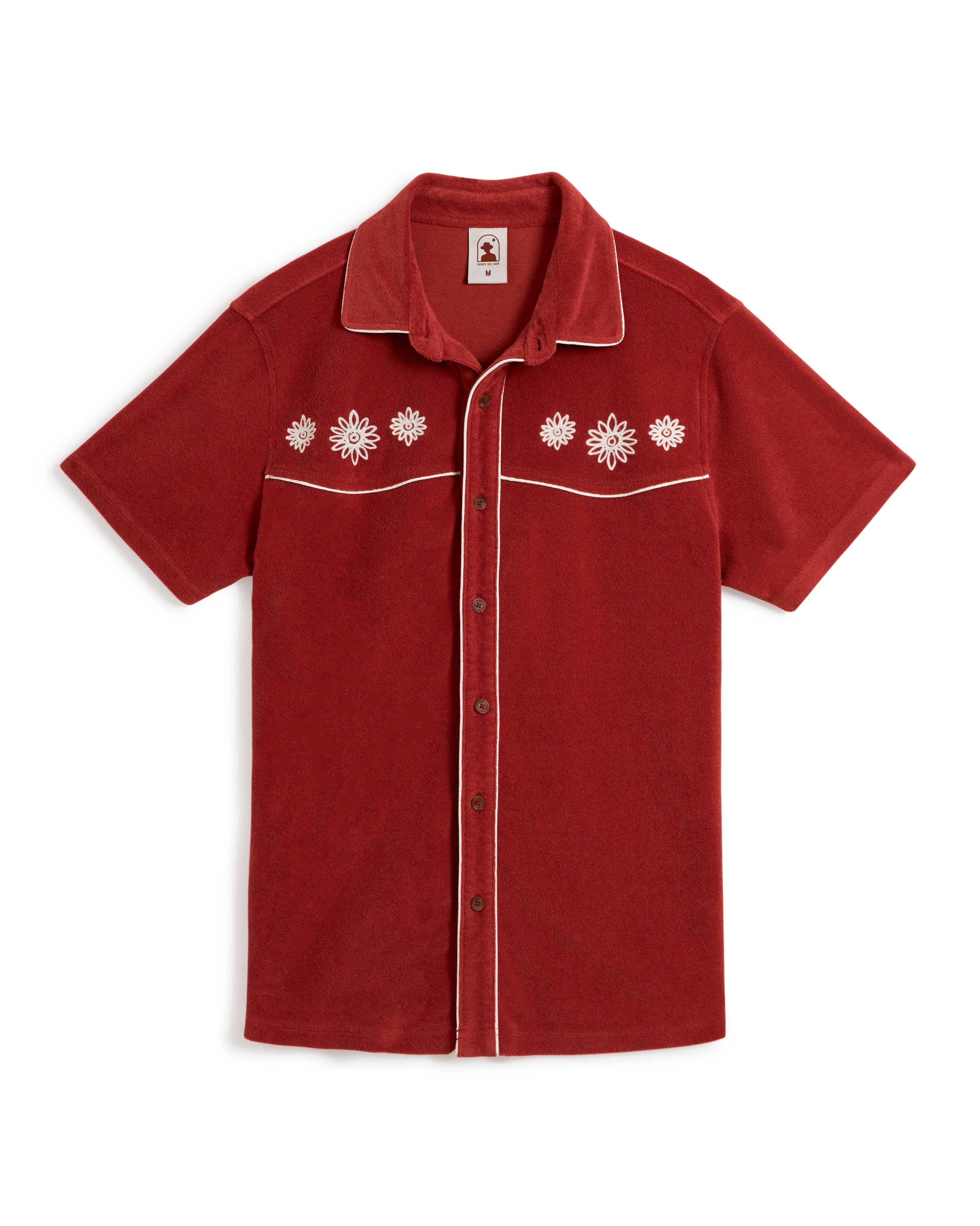 The Gaucho Shirt - Rouge by Dandy Del Mar is a red short-sleeve button-up with white floral embroidery on the chest and elegant piping along the seams, beautifully displayed on a white background.