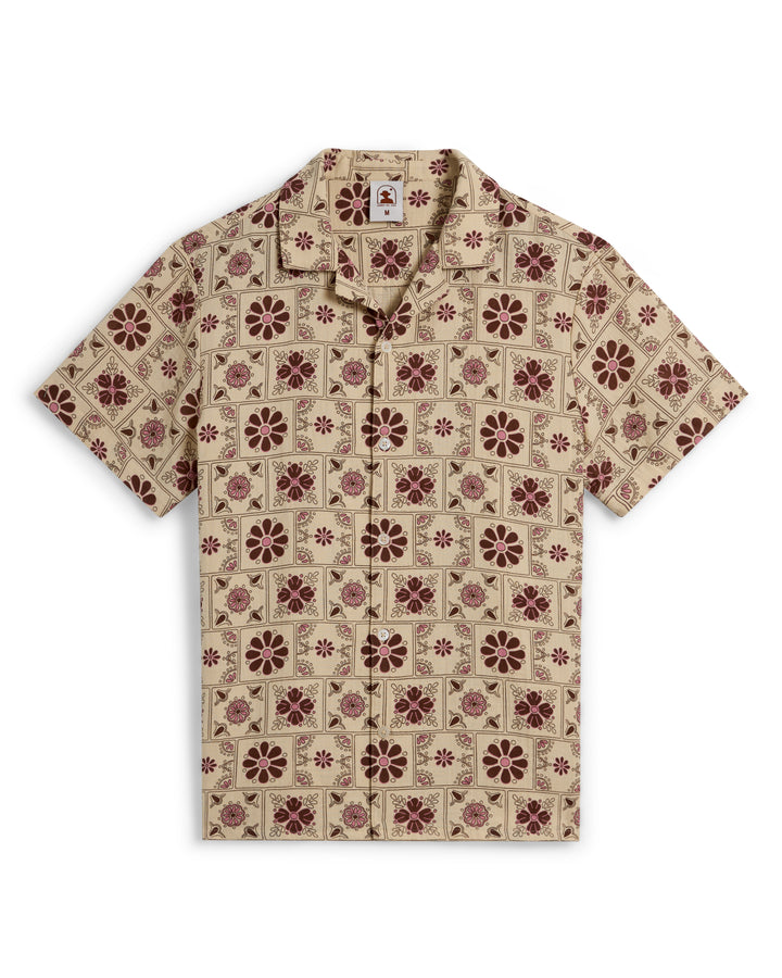 The Dandy Del Mar Grenadine Crinkle Gauze Shirt in Sabbia features a short-sleeve design with a geometric and dark red floral pattern.