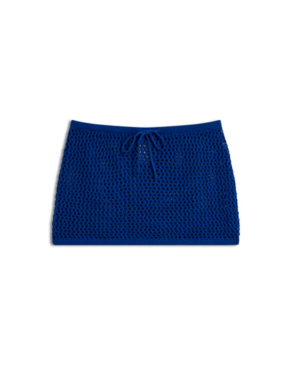 The Dandy Del Mar "The Malaga Crochet Skirt - Solana" is a blue knitted mini skirt featuring a drawstring waist, shown on a white background.