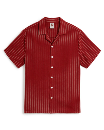 Introducing The Palma Shirt - Garam by Dandy Del Mar: a short-sleeve, button-up shirt featuring thin white vertical stripes on a red background and a stylish camp collar.