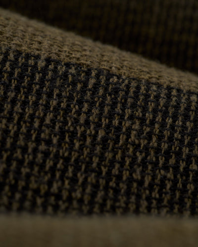 Close-up of The Palma Shorts - Onyx by Dandy Del Mar, showcasing a textured brown and black yarn-dyed stripe canvas with a grid-like woven pattern.
