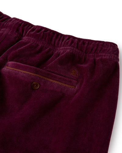 Close-up of The Rio Velour Shorts in Bordeaux by Dandy Del Mar, featuring an elastic waistband, a back pocket with a brown button, and a thin trim above the pocket—a standout piece in men's leisurewear.