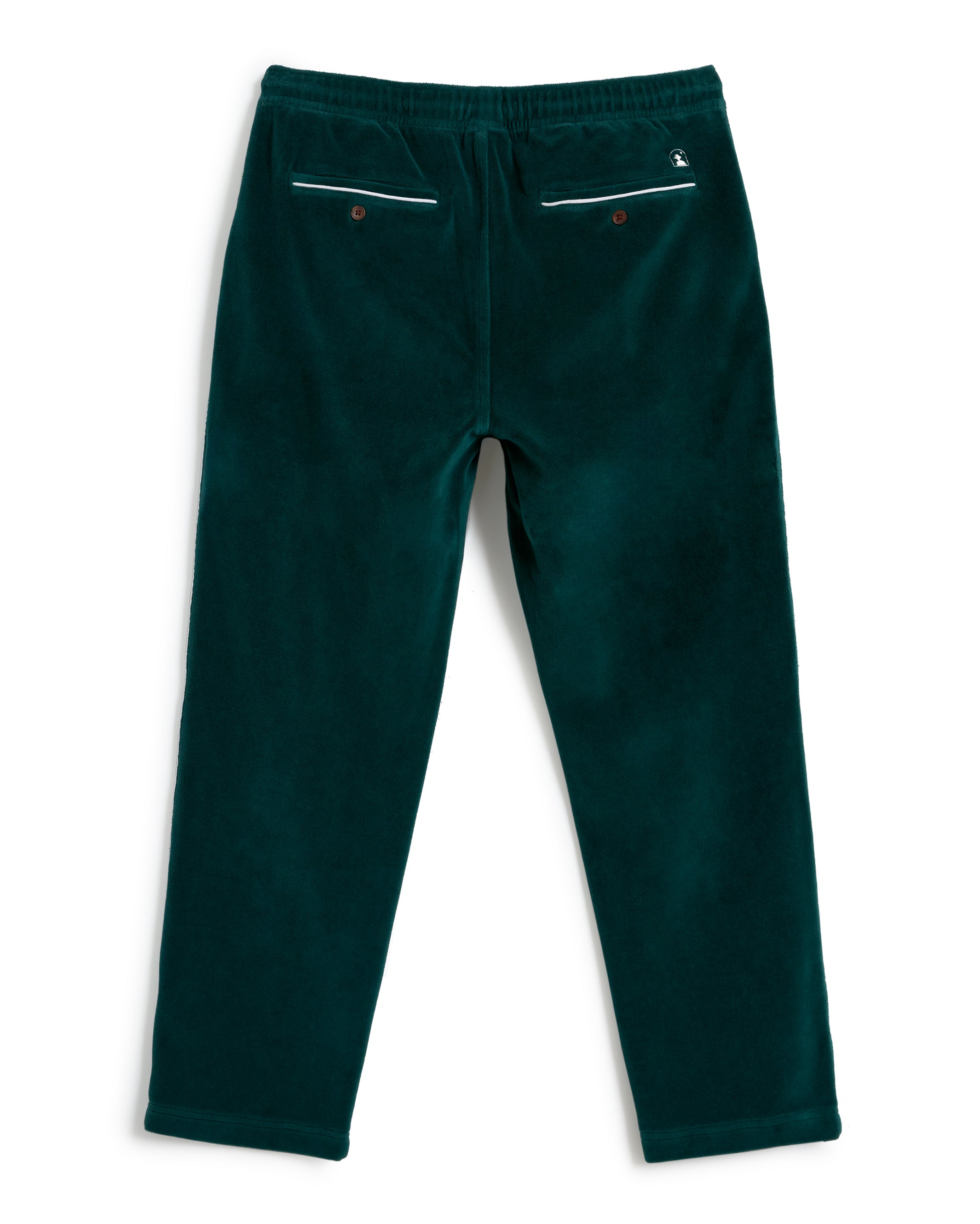 A pair of The Rio Velour Pant - Albero by Dandy Del Mar in dark green with a relaxed fit, an elastic waistband, and two back pockets featuring button closures and white trim.