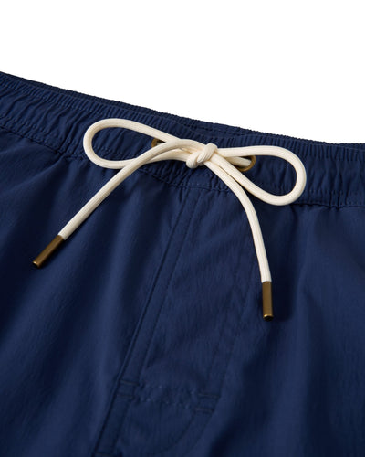 Close-up of The Ventura Volley Shorts - Anchor by Dandy Del Mar in blue, featuring an elastic waistband and white drawstring with metal tips—ideal men's swimwear for style and comfort.