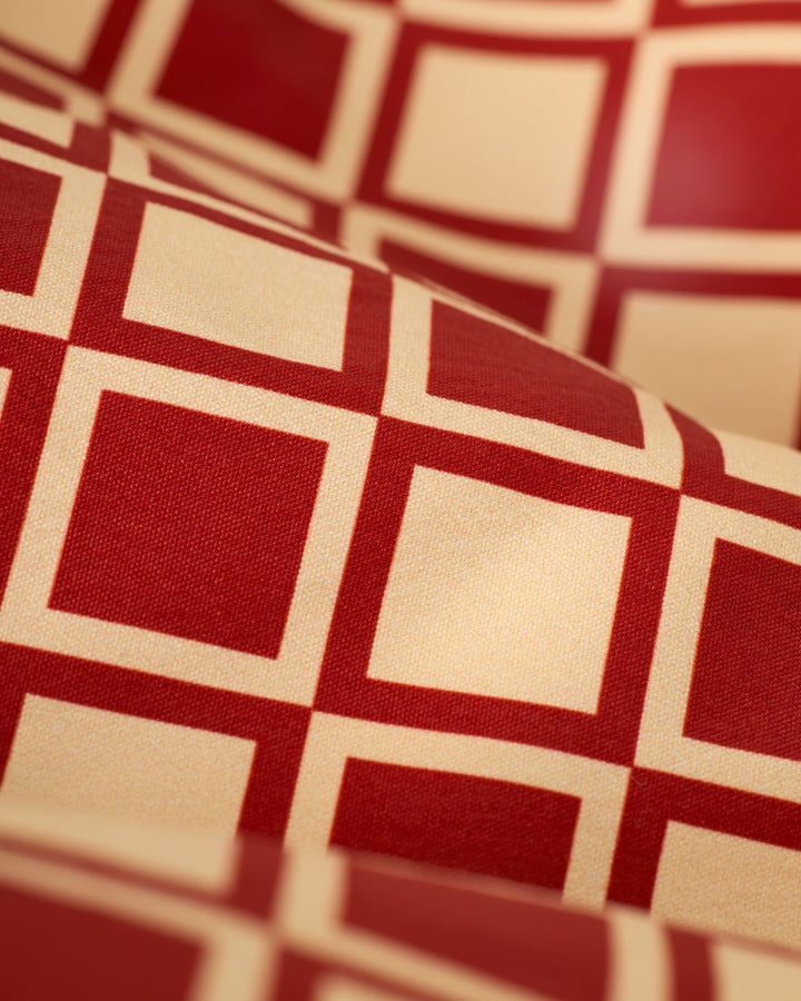 Close-up of The Ventura Volley Short - Rouge by Dandy Del Mar, featuring a red and beige checkerboard pattern.