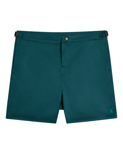 The Mallorca Swim-Walk Shorts by Dandy Del Mar in Tempest Blue are men's swim shorts made from single-layer nylon, with adjustable brass fasteners, a button closure, and a subtle logo on the front lower hem. Shown against a white background.