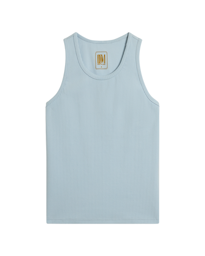 The Milan Rib Tank - Comet by Dandy Del Mar is a light blue rib knit tank with an athletic silhouette, a scoop neckline, and a small beige label inside the back collar featuring the initials "DM.