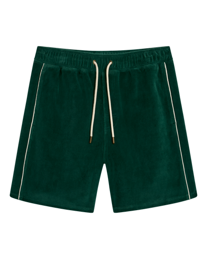 The Rio Velour Short - Albero by Dandy Del Mar features dark green velour fabric, an elastic waistband, white drawstrings, and white piping along the side seams. Displayed flat on a plain background.