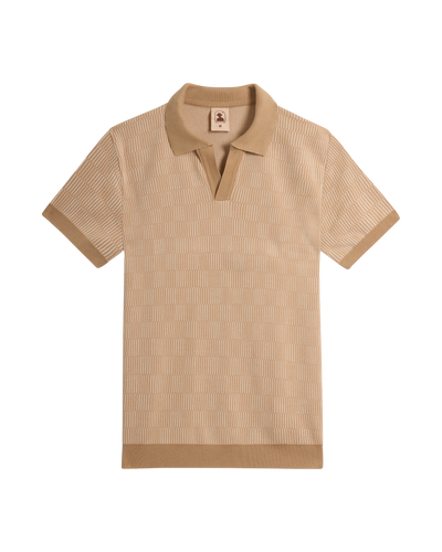 The Sebastian Knit Polo Shirt - Shell by Dandy Del Mar is a short-sleeve beige Italian knit with a textured pattern, open collar, and ribbed cuffs and hem, shown laid flat on a white background.