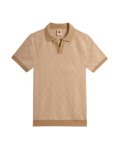 The Sebastian Knit Polo - Shell by Dandy Del Mar: a beige, short-sleeve Italian knit polo with textured pattern, open collar, and ribbed cuffs and hem. This buttonless shirt offers effortless style with refined detail.