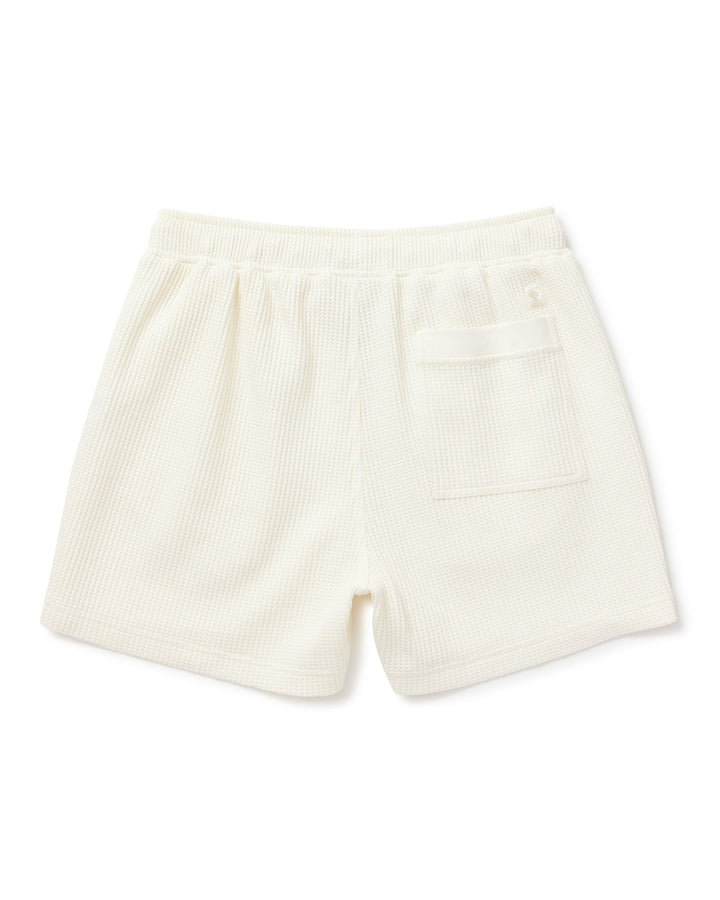 A Dandy Del Mar Cannes Waffle Knit Shorts - Vintage Ivory with a pocket on the side.