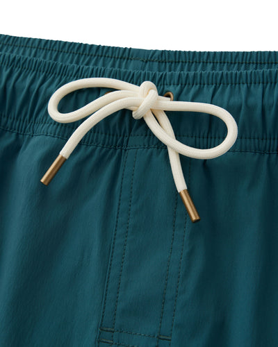 Close-up of The Ventura Volley Shorts - Acqua by Dandy Del Mar in teal, with white drawstring, brass aglets, visible stitching, and elastic waistband—an essential piece for men’s swimwear.
