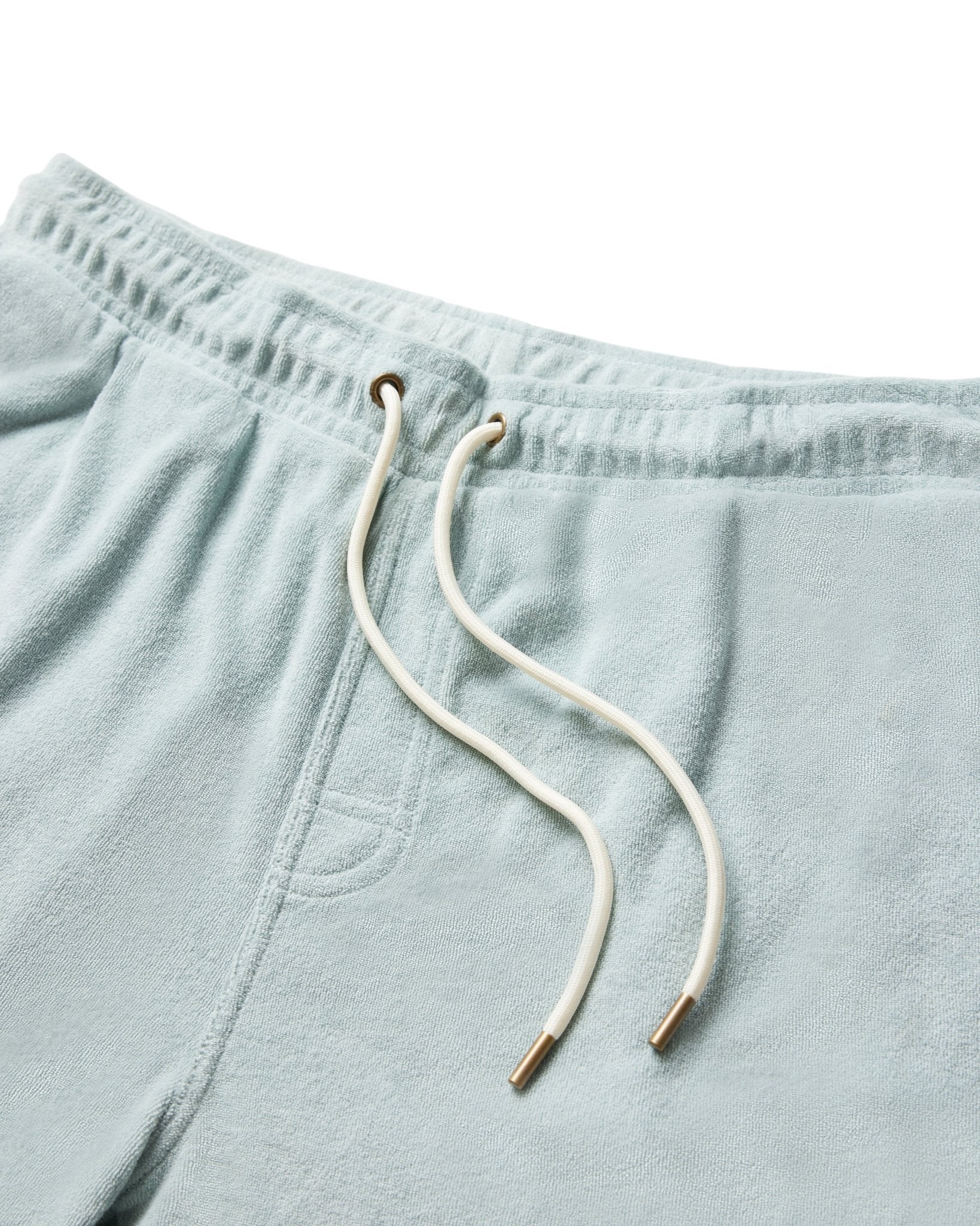 Close-up of The Tropez Terry Cloth Shorts - Gulf Blue by Dandy Del Mar, made from soft terry cloth with an elastic waistband, white drawstrings, and metal tips.