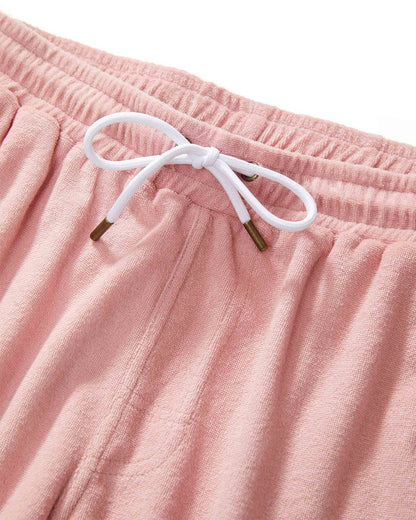 Close-up of Dandy Del Mar's The Gaucho Shorts in mauve, showcasing an elastic waistband paired with a white bow-tied drawstring.